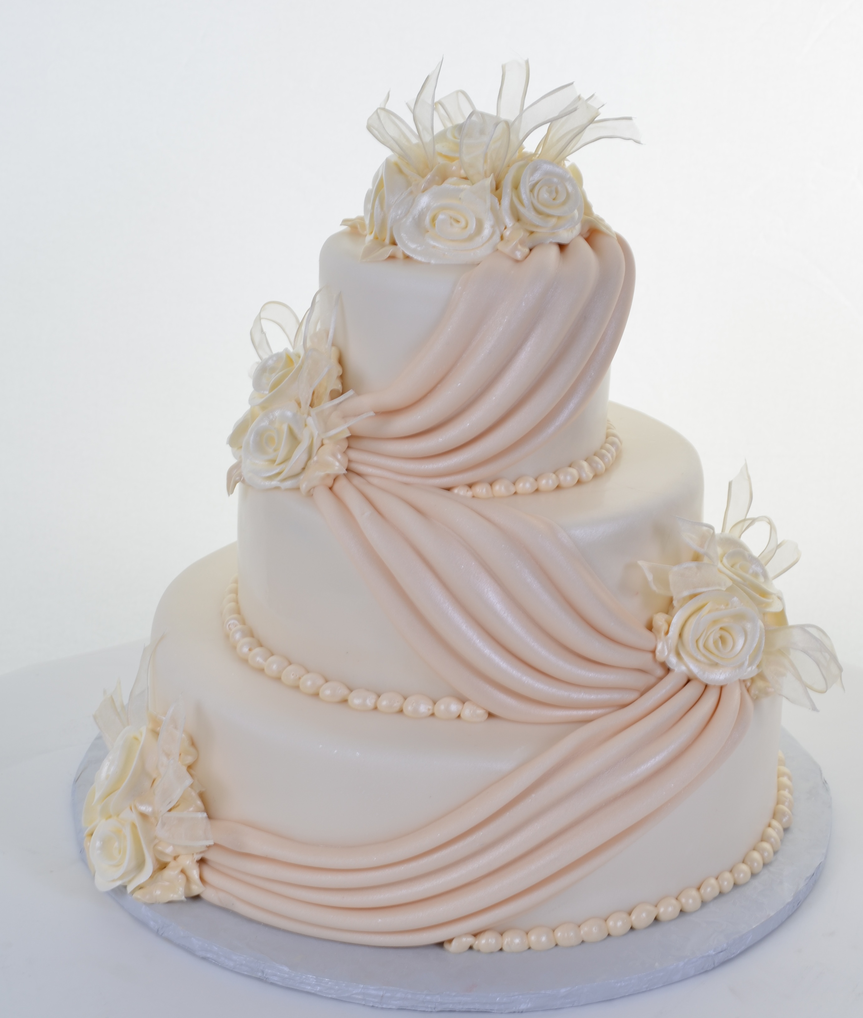 W583 – Ivory Icing, Champagne Drapes – Wedding Cakes 